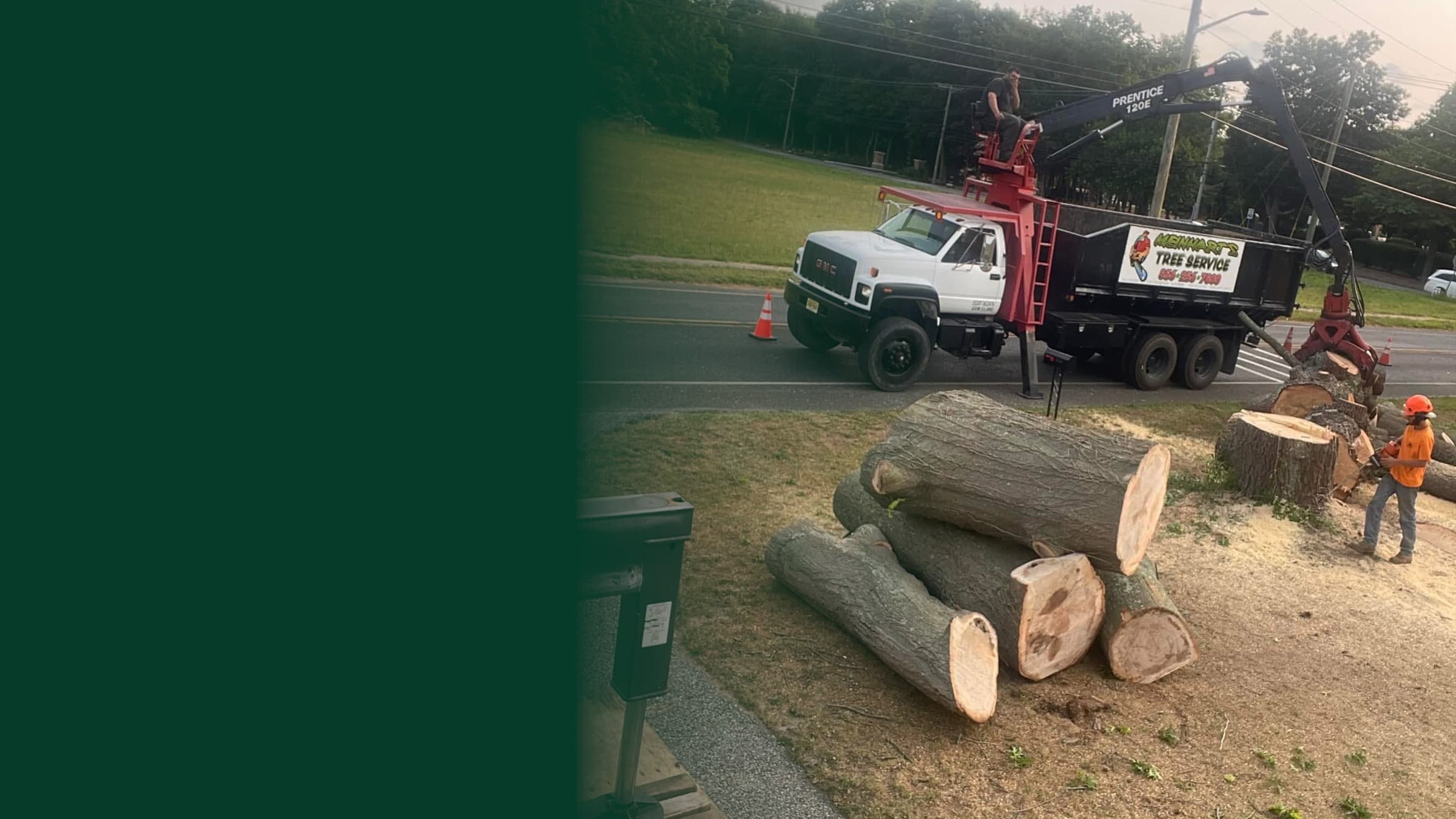 Meinhart's Tree Service crew loading large tree sections with a grapple truck