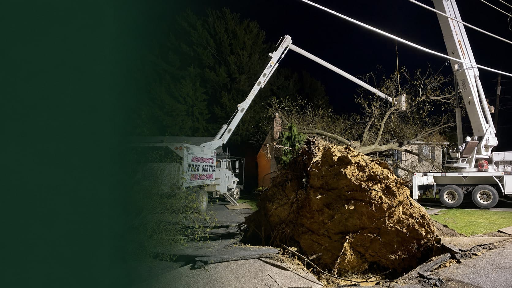 Meinhart's Tree Service equipment responding to a large uprooted tree at night